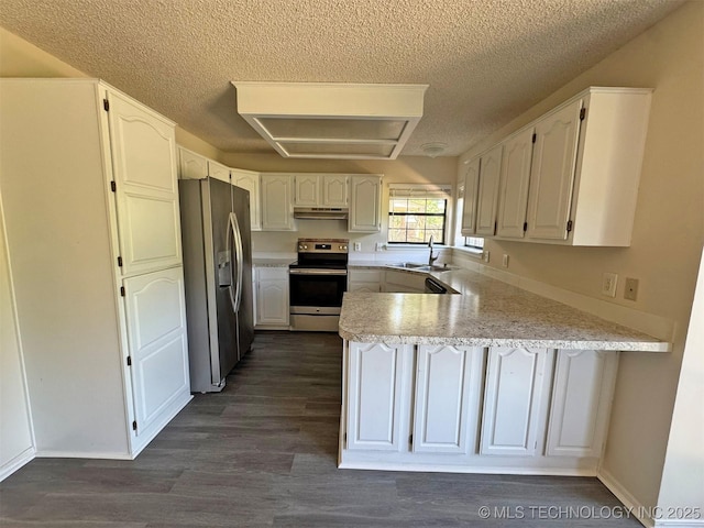 7333 W 36th St, Tulsa, OK 74107 - kitchen with appliances with stainless steel finishes, under cabinet range hood, a peninsula, a sink, and a textured ceiling