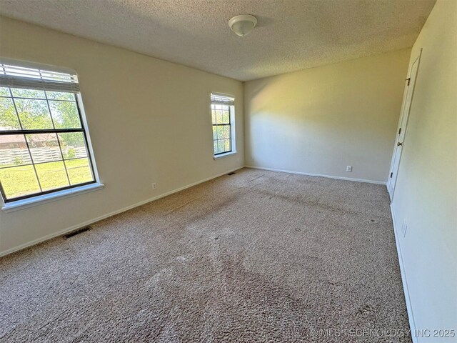7333 W 36th St, Tulsa, OK 74107 - empty room with a textured ceiling, carpet floors, and baseboards