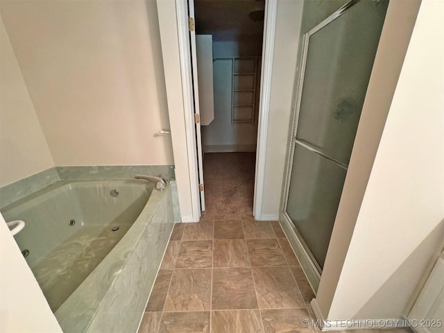 7333 W 36th St, Tulsa, OK 74107 - bathroom featuring a stall shower, a tub with jets, and baseboards