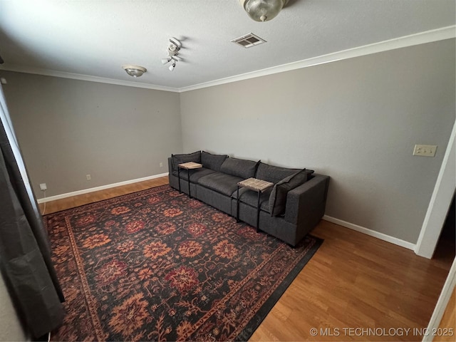 2836 E Admiral Blvd, Tulsa, OK 74110 - living area featuring wood finished floors, ornamental molding, and baseboards