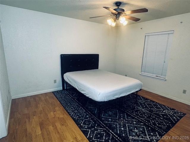 2836 E Admiral Blvd, Tulsa, OK 74110 - bedroom featuring wood finished floors, baseboards, a ceiling fan, and a textured ceiling