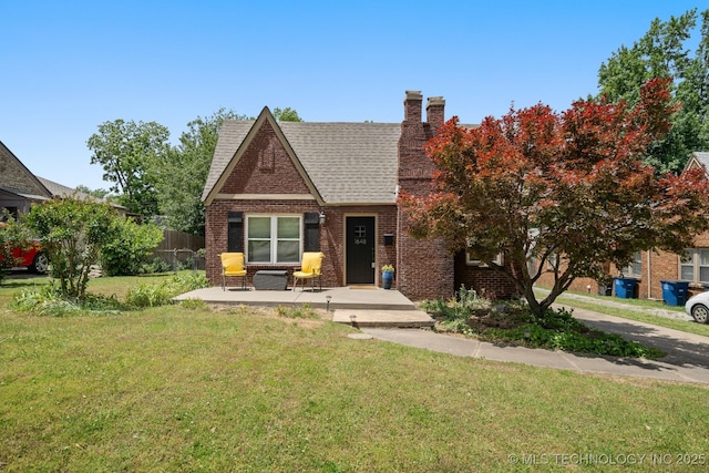 1648 S Columbia Pl, Tulsa, OK 74104 - tudor home with brick siding, a chimney, and roof with shingles
