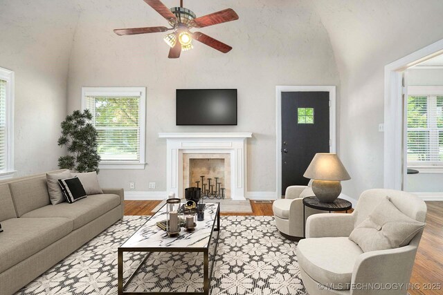 1648 S Columbia Pl, Tulsa, OK 74104 - living room with lofted ceiling, plenty of natural light, ceiling fan, wood finished floors, and baseboards