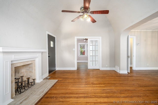 1648 S Columbia Pl, Tulsa, OK 74104 - unfurnished living room with a ceiling fan, lofted ceiling, arched walkways, wood finished floors, and baseboards
