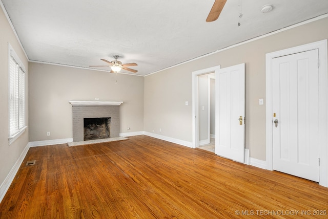 1648 S Columbia Pl, Tulsa, OK 74104 - unfurnished living room with a ceiling fan, wood finished floors, a fireplace, ornamental molding, and baseboards