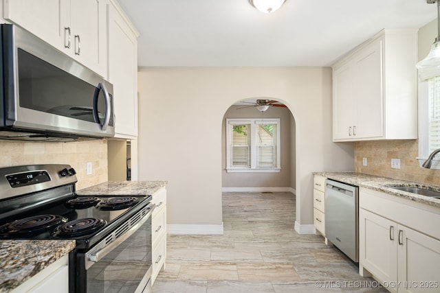 1648 S Columbia Pl, Tulsa, OK 74104 - kitchen featuring appliances with stainless steel finishes, a sink, baseboards, and backsplash