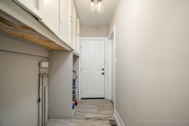 1648 S Columbia Pl, Tulsa, OK 74104 - corridor with a chandelier and baseboards