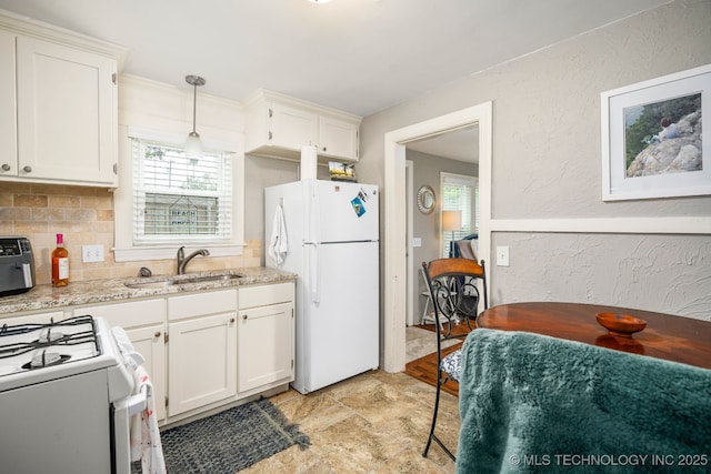 1648 S Columbia Pl, Tulsa, OK 74104 - kitchen with white appliances, a sink, plenty of natural light, stone finish flooring, and a textured wall