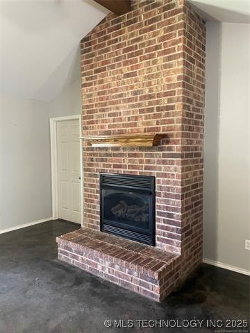 221 S Smith, Bennington, OK 74723 - unfurnished living room with lofted ceiling, baseboards, a brick fireplace, and carpet