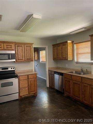 221 S Smith, Bennington, OK 74723 - kitchen with stainless steel appliances, a sink, and brown cabinets