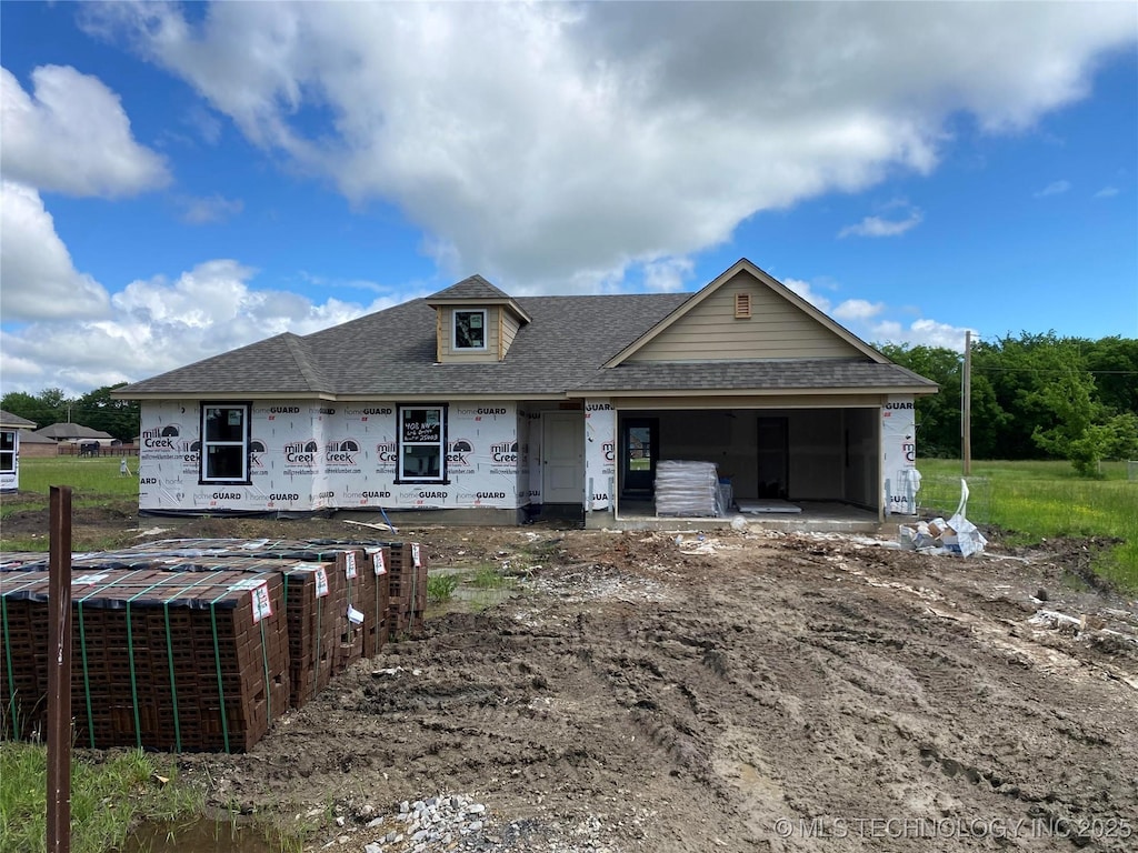unfinished property with a shingled roof