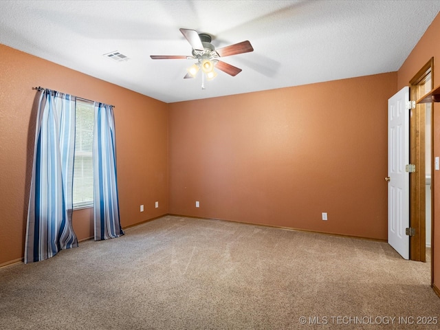 1310 Prairie Heights Dr, Bartlesville, OK 74006 - spare room with a ceiling fan, carpet floors, and baseboards