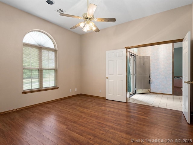 1310 Prairie Heights Dr, Bartlesville, OK 74006 - empty room featuring wood finished floors, ceiling fan, and baseboards