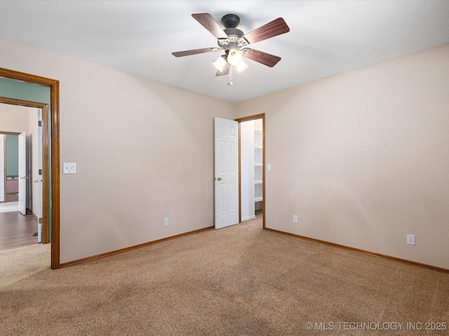 1310 Prairie Heights Dr, Bartlesville, OK 74006 - empty room featuring carpet, baseboards, and a ceiling fan