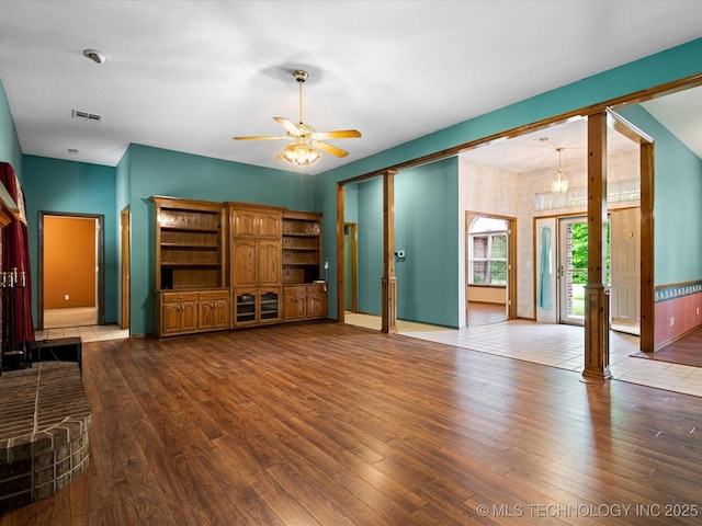 1310 Prairie Heights Dr, Bartlesville, OK 74006 - unfurnished living room featuring wood finished floors, ceiling fan, and baseboards