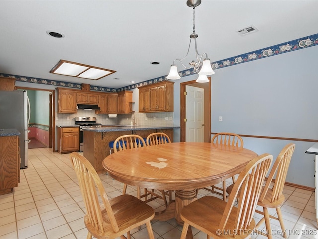 1310 Prairie Heights Dr, Bartlesville, OK 74006 - dining room with light tile patterned flooring and baseboards