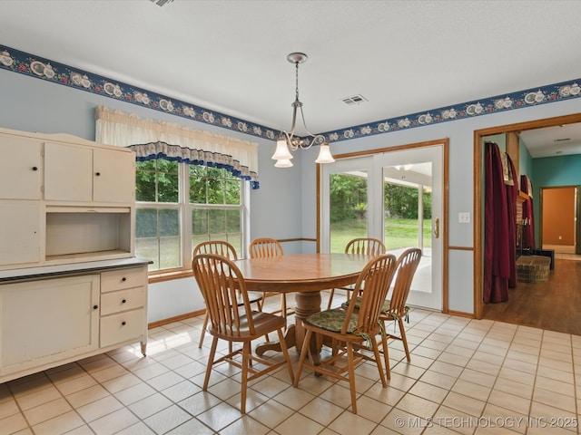 1310 Prairie Heights Dr, Bartlesville, OK 74006 - dining room with light tile patterned floors, baseboards, and a chandelier
