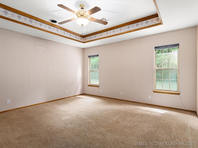 1310 Prairie Heights Dr, Bartlesville, OK 74006 - unfurnished room with carpet floors, healthy amount of natural light, a tray ceiling, and crown molding