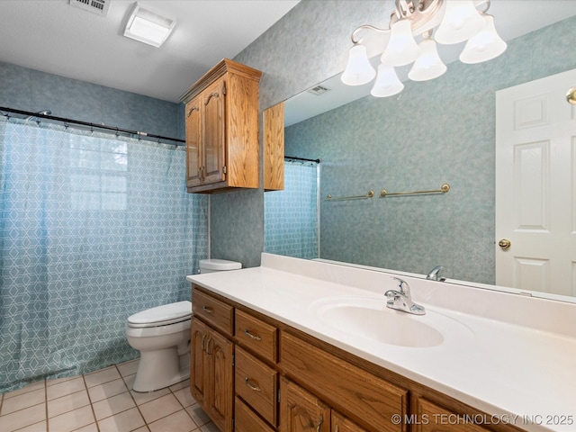 1310 Prairie Heights Dr, Bartlesville, OK 74006 - bathroom featuring tile patterned floors, toilet, vanity, a chandelier, and wallpapered walls
