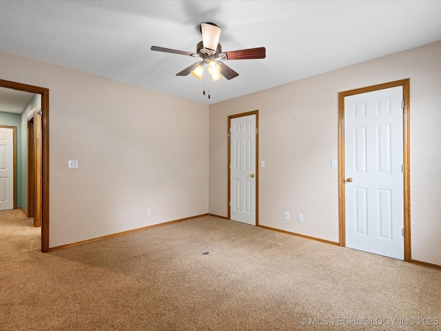 1310 Prairie Heights Dr, Bartlesville, OK 74006 - unfurnished bedroom featuring light colored carpet, baseboards, and a ceiling fan