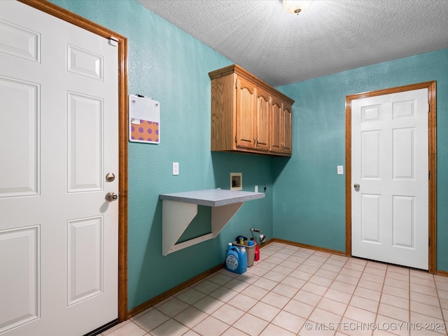 1310 Prairie Heights Dr, Bartlesville, OK 74006 - washroom with a textured ceiling, cabinet space, washer hookup, light tile patterned floors, and baseboards