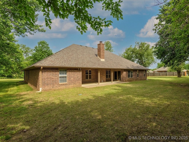 1310 Prairie Heights Dr, Bartlesville, OK 74006 - back of property featuring a patio, a chimney, brick siding, and a shingled roof