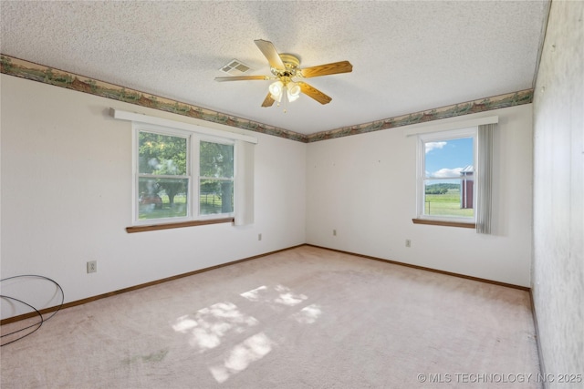 20600 Slick Rd, Kellyville, OK 74039 - carpeted spare room with plenty of natural light, a ceiling fan, a textured ceiling, and baseboards