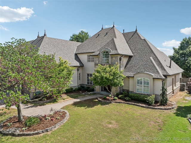 11408 S Harvard Ave, Tulsa, OK 74137 - french country style house featuring a front yard, stucco siding, a shingled roof, and stone siding