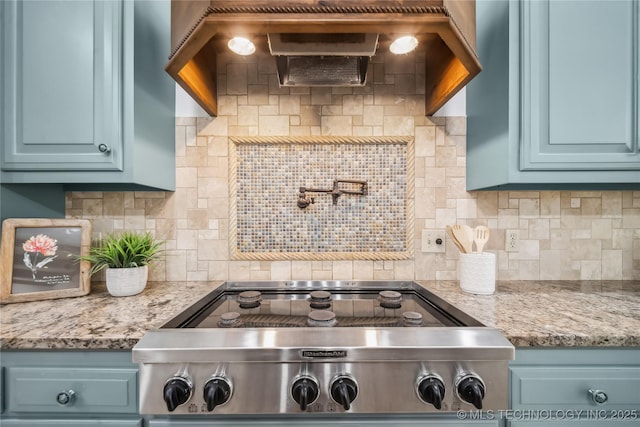 11408 S Harvard Ave, Tulsa, OK 74137 - kitchen with stainless steel gas stovetop, decorative backsplash, blue cabinets, and light stone counters