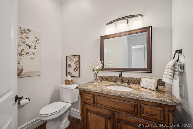 11408 S Harvard Ave, Tulsa, OK 74137 - bathroom with wood finished floors, vanity, toilet, and baseboards