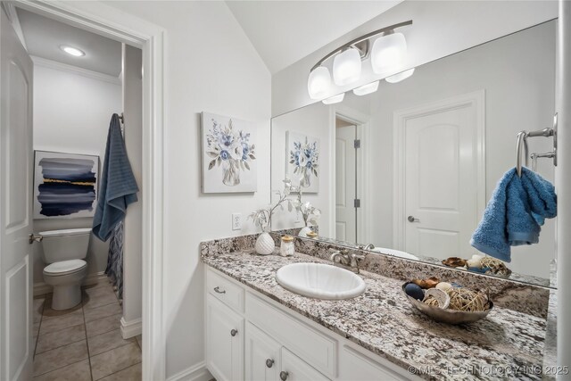11408 S Harvard Ave, Tulsa, OK 74137 - bathroom with vanity, tile patterned floors, vaulted ceiling, toilet, and baseboards