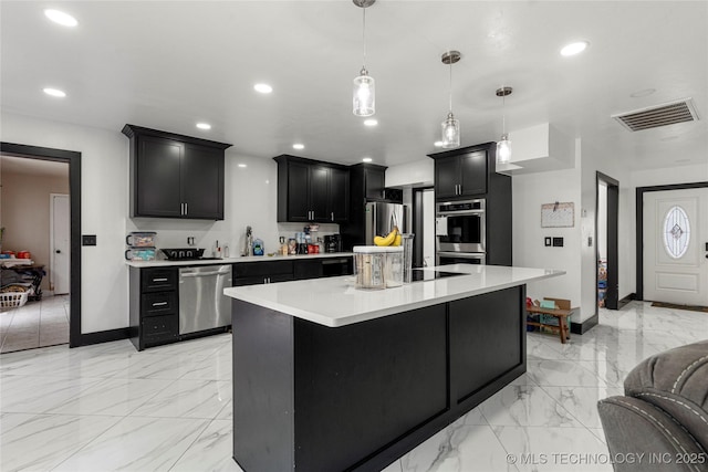 2122 E 52nd St, Tulsa, OK 74105 - kitchen featuring stainless steel appliances, dark cabinetry, light countertops, light marble finish flooring, and recessed lighting