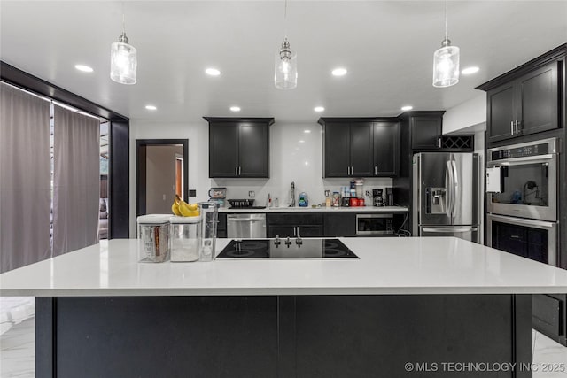 2122 E 52nd St, Tulsa, OK 74105 - kitchen with appliances with stainless steel finishes, a sink, light countertops, recessed lighting, and decorative light fixtures