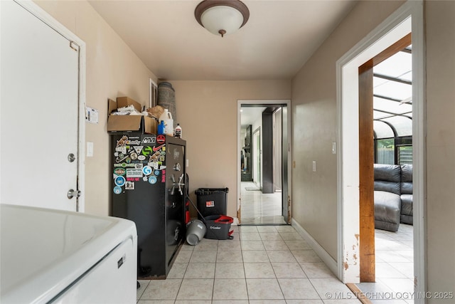 2122 E 52nd St, Tulsa, OK 74105 - washroom featuring washer / clothes dryer, light tile patterned floors, and baseboards