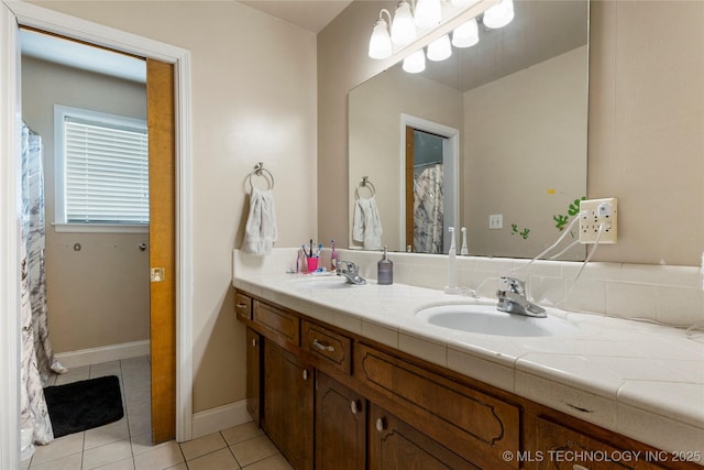 2122 E 52nd St, Tulsa, OK 74105 - full bath with tile patterned flooring, double vanity, and baseboards