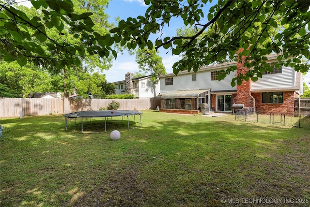 2122 E 52nd St, Tulsa, OK 74105 - view of yard with a trampoline and a sunroom