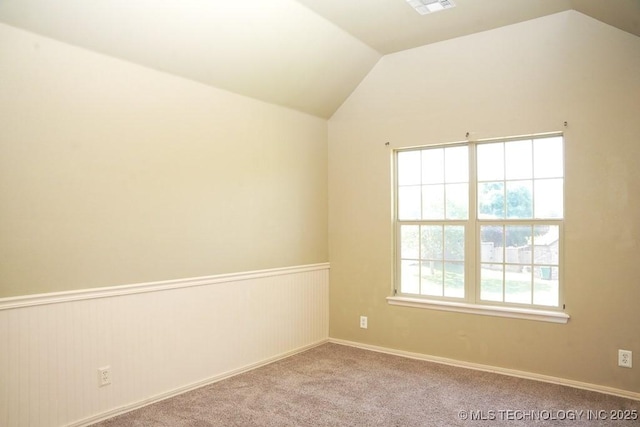 717 W 39th St, Sand Springs, OK 74063 - spare room with vaulted ceiling, carpet flooring, and wainscoting