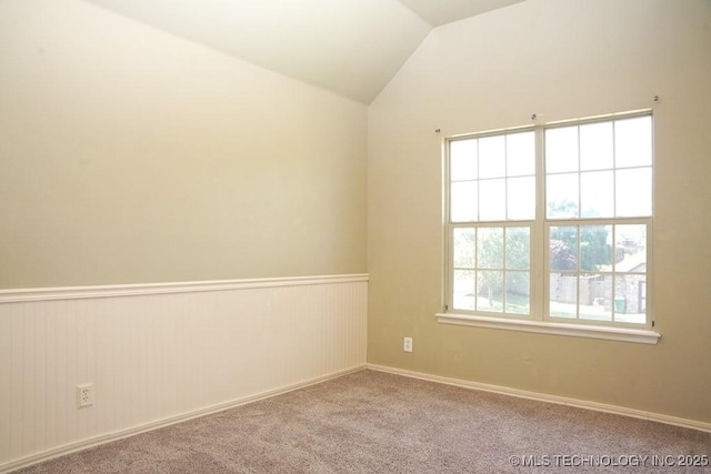 717 W 39th St, Sand Springs, OK 74063 - empty room with a wainscoted wall, lofted ceiling, and carpet flooring