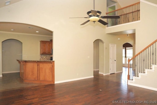 717 W 39th St, Sand Springs, OK 74063 - unfurnished living room with ceiling fan, dark wood finished floors, crown molding, a high ceiling, and baseboards