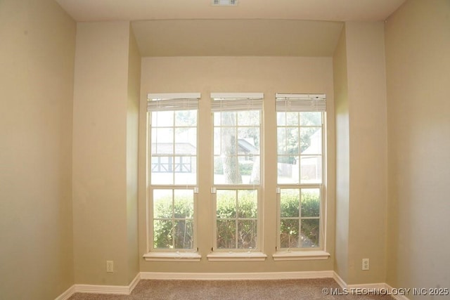 717 W 39th St, Sand Springs, OK 74063 - carpeted empty room with healthy amount of natural light and baseboards