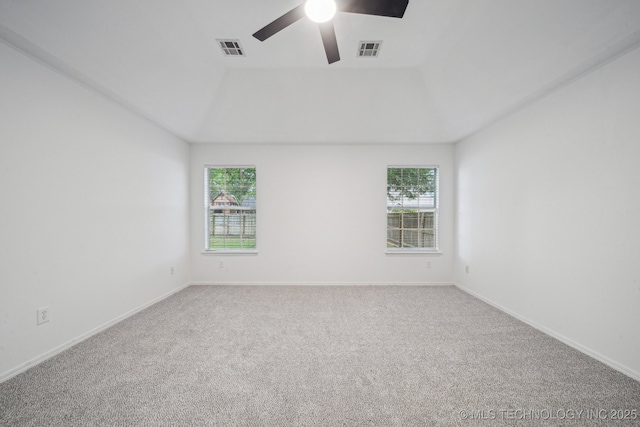 carpeted spare room featuring ceiling fan and baseboards