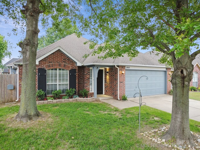 view of front of property featuring brick siding, a garage, a shingled roof, and driveway