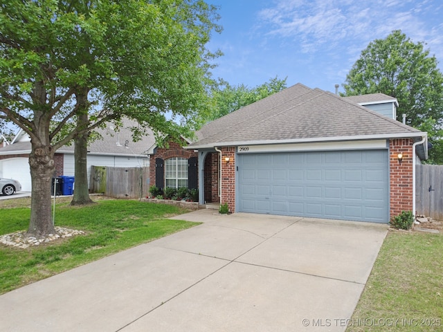 view of front facade featuring brick siding, driveway, a shingled roof, and an attached garage