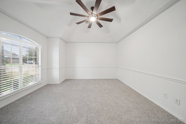 carpeted spare room with a ceiling fan, lofted ceiling, and baseboards