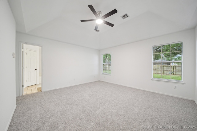 empty room with healthy amount of natural light, carpet, ceiling fan, and baseboards