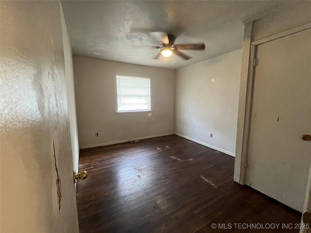 628 S 105th E Pl, Tulsa, OK 74128 - unfurnished bedroom with wood finished floors, baseboards, and a ceiling fan