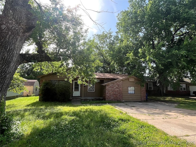 628 S 105th E Pl, Tulsa, OK 74128 - view of front of home with brick siding, concrete driveway, and a front lawn