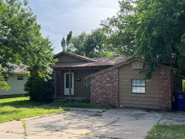 628 S 105th E Pl, Tulsa, OK 74128 - view of front of home with brick siding, a porch, and board and batten siding