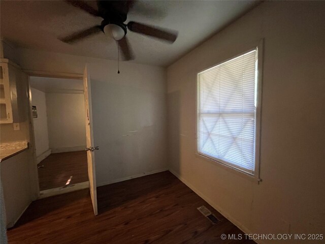 628 S 105th E Pl, Tulsa, OK 74128 - empty room with dark wood-style flooring, a ceiling fan, and baseboards