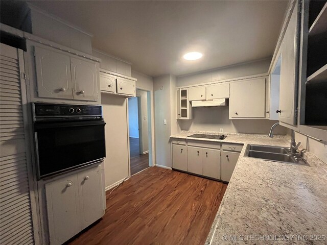 628 S 105th E Pl, Tulsa, OK 74128 - kitchen with black appliances, a sink, under cabinet range hood, dark wood-type flooring, and white cabinets